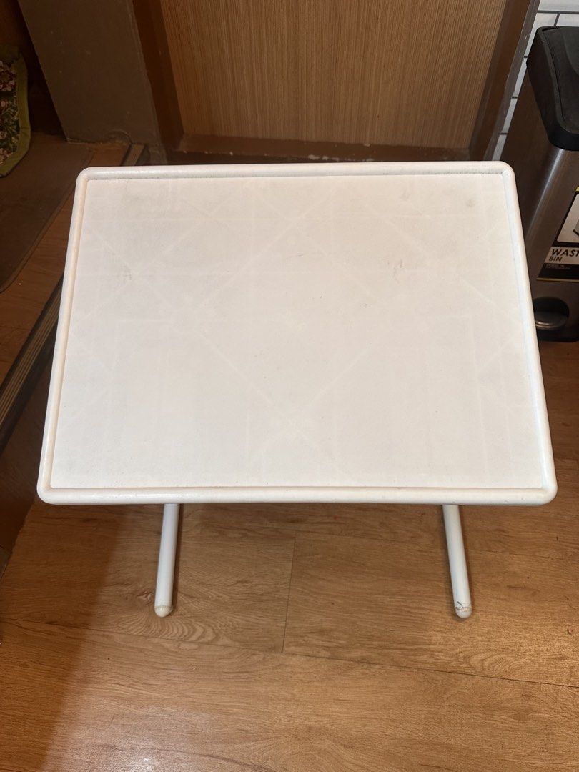 White foldable plastic study table TV tray (Category: Tables & Sets) located in Quezon City. Submitted by k_prelovedpieces (Listing ID 1466395227, Image 1). Description: - Color: White with sturdy metal legs - Design: Foldable for easy storage - Size: Compact, ideal for small rooms, balconies, or bedside use - Condition: Light surface marks from regular usage, structure is 100% sturdy - Multi-purpose: Great for studying, eating, or working on lap
