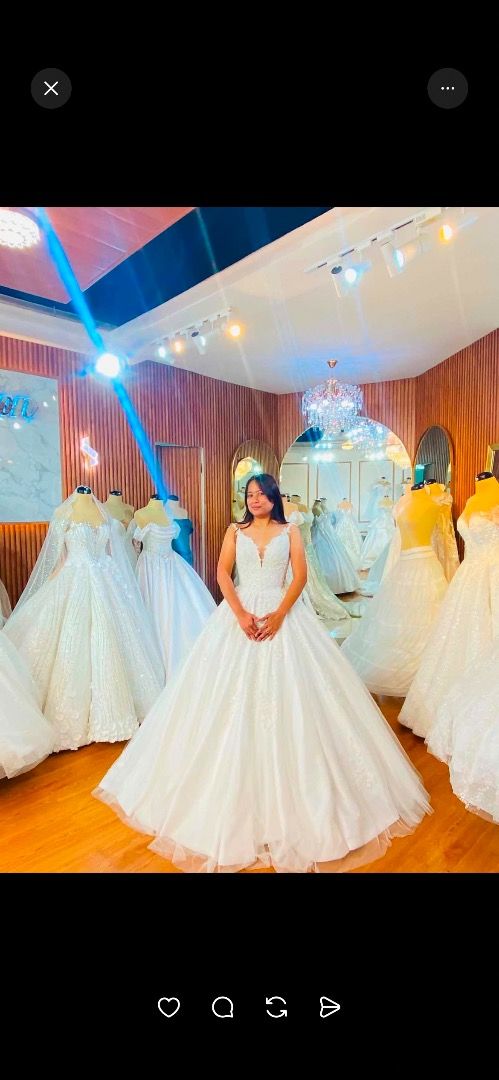 White lace wedding gown with long train (Category: Evening dresses & gowns) located in Caloocan City. Submitted by rhianskie (Listing ID 1466374918, Image 1). Description: - Condition: Worn only during my wedding - Style: sleeveless bodice with intricate lace detailing - Skirt: Full, voluminous ballgown skirt layered in tulle - Back Design: Deep V-back with a delicate row of buttons - Train: Dramatic floor-sweeping train with a sheer outer tulle 