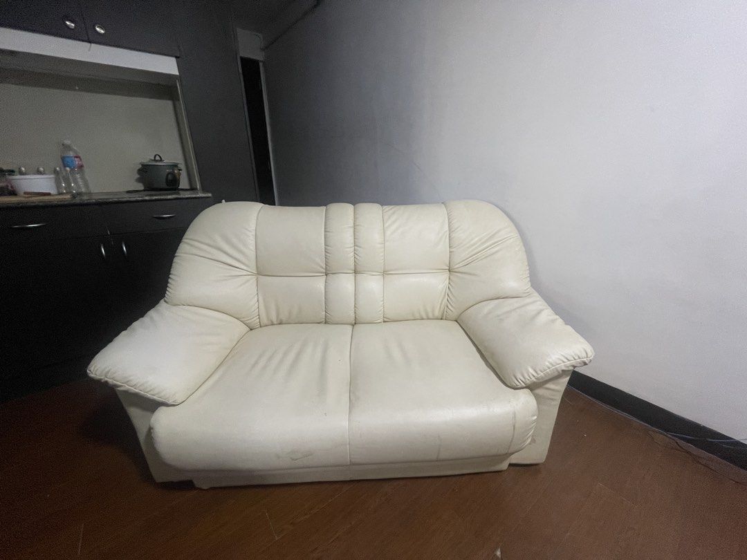 White Leather 2-Seater Sofa (Category: Sofas) located in Manila. Submitted by jennyrosebabor02 (Listing ID 1466343320, Image 1). Description: - Color & Material: White leather 2-seater couch - Design: Clean minimalist style that fits most living rooms - Comfort: Generously padded armrests and supportive back cushioning with segmented panels - Build: Solid, sturdy frame underneath with standard double-seater dimensions - Condition: Good overall co