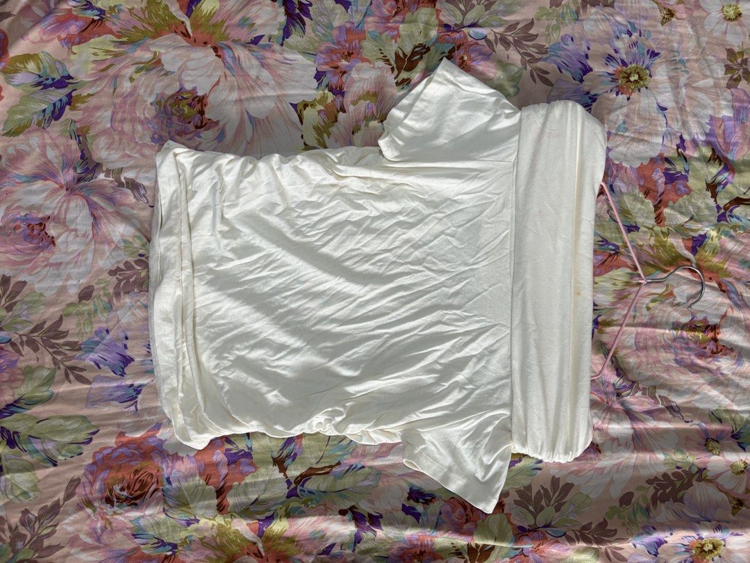 White Off shoulder Short Sleeve Top (Category: Shirts) located in Paranaque City. Submitted by delikaite (Listing ID 1466414825, Image 2). Description: - Color: White - Style: Short sleeve top with draped cowl neckline and side ruching - Material: Soft ribbed fabric - Fit: Perfect for pairing with high-waisted jeans or skirts - Condition: Good, but has a faint reddish stain on the front chest area - Occasion: Casual everyday wear.