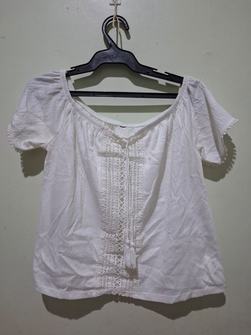 White off-shoulder top with lace panel and tassels (Category: Blouses) located in Tuguegarao City. Submitted by potaetonim (Listing ID 1466483680, Image 1). Description: free if you buy. pls request if interested - Color: White - Style: Off-shoulder top with short sleeves - Details: Center front crochet lace panel with neckline tassels and pom-pom sleeve hems - Fabric: Lightweight and breezy crinkled material - Fit: Relaxed fit, standard sizing -
