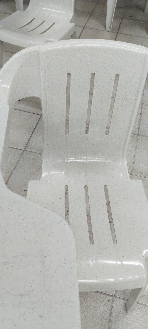 White plastic armchairs with attached writing tablets (Category: Chairs) located in Cebu City. Submitted by cleverwind_557624 (Listing ID 1466364520, Image 2). Description: - White plastic chairs with sturdy writing armrests - Slotted backrests and seats for cool, comfortable seating - Durable and reliable build for daily use - Perfect for classrooms, training centers, and study spaces - Multiple units available - Clean surfaces, ready for pickup