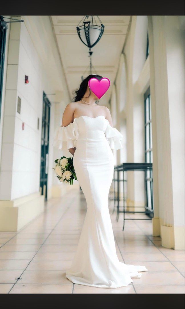 White Wedding Dress Large (Category: Evening dresses & gowns) located in Pasay City. Submitted by kimverlygo50697 (Listing ID 1466399101, Image 1). Description: - Color: White - Size: Large - Neckline: Sweetheart - Sleeves: Ruffled cold-shoulder - Silhouette: Fitted with a long floor-sweeping train - Style: Simple and clean design.