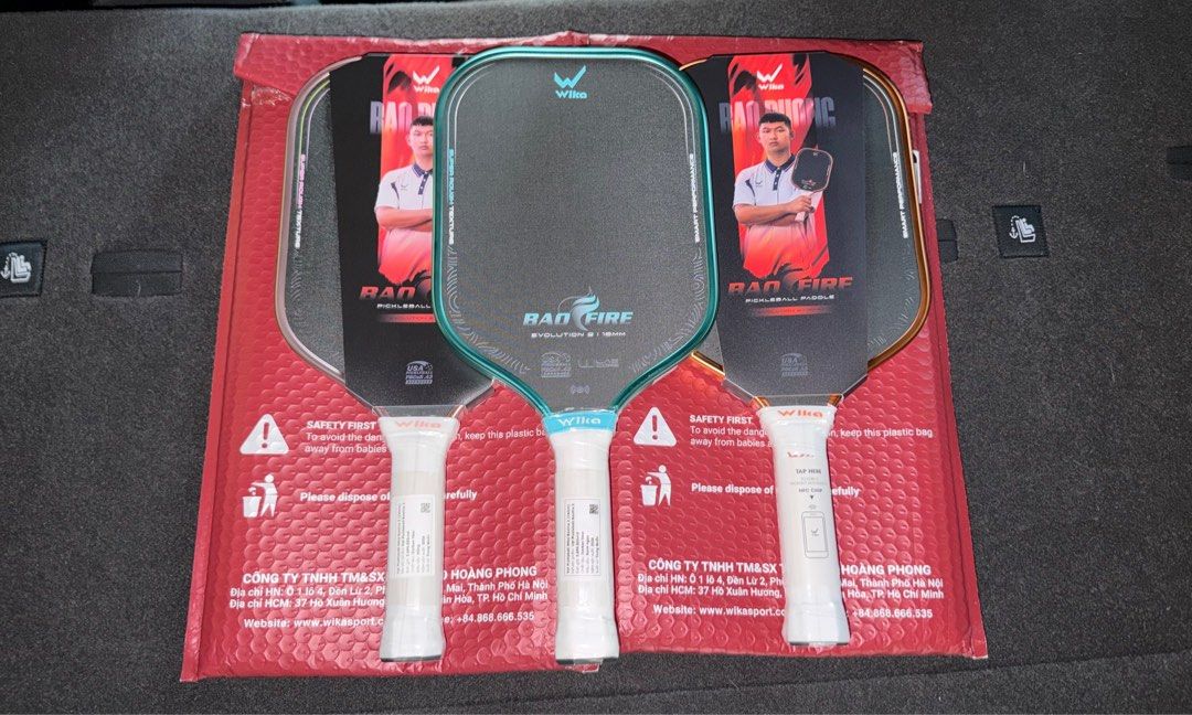 Wilka Bao Fire 2 Evolution Pickleball Paddle 16mm (Category: Racket and Ball Sports) located in Manila. Submitted by sneakspxxks (Listing ID 1466403064, Image 1). Description: - Brand: Wilka Bad Fire Evolution 16mm Pickleball Paddles - Available Colors: Teal, Pinkish-Orange, and Gold (3 pieces total) - Condition: Brand new, handles still wrapped in plastic, and protective cardboard sleeve over hitting surface - Flexibility: Pick your favorite col