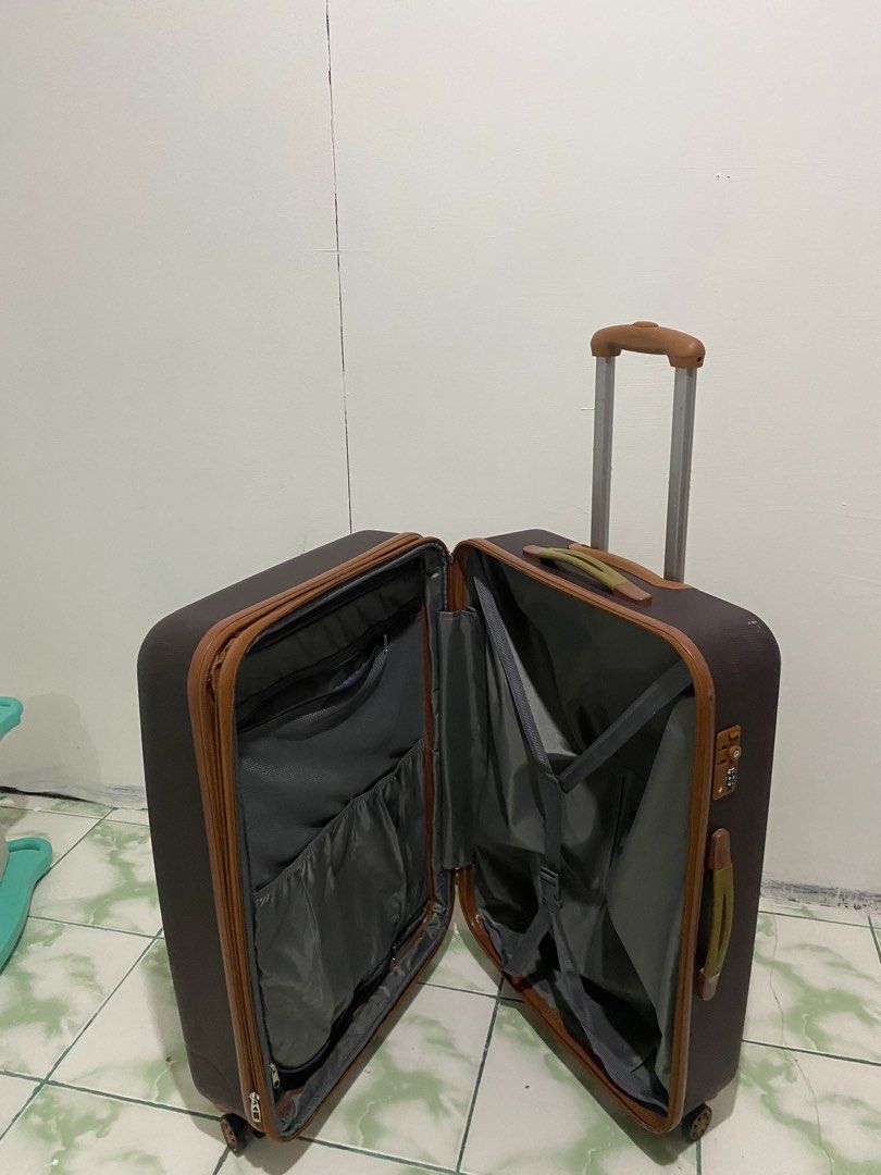 XL Brown hard shell luggage with spinner wheels (Category: Luggage) located in Caloocan City. Submitted by saharalim88430 (Listing ID 1466513745, Image 2). Description: - Elegant brown hardshell design with chic tan trim details - Smooth-gliding 4-spinner wheels for effortless mobility - Retractable top and side handles for easy carrying - Built-in side combination lock for added security - Organized interior featuring grey lining, zipper compart