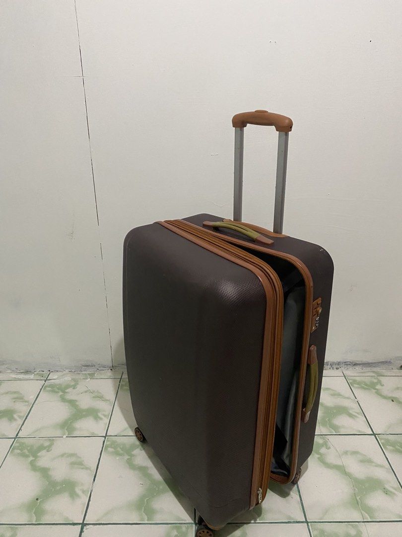 XL Brown hard shell luggage with spinner wheels (Category: Luggage) located in Caloocan City. Submitted by saharalim88430 (Listing ID 1466513745, Image 3). Description: - Elegant brown hardshell design with chic tan trim details - Smooth-gliding 4-spinner wheels for effortless mobility - Retractable top and side handles for easy carrying - Built-in side combination lock for added security - Organized interior featuring grey lining, zipper compart