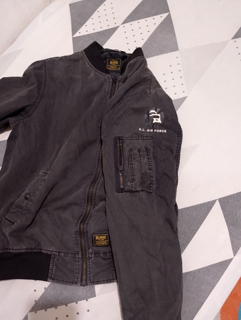 XLARGE Type DL-1 Bomber Jacket Black Size L (Category: Coats, Jackets and Outerwear) located in Cavite. Submitted by marvzclothing (Listing ID 1466458441, Image 3). Description: - Brand: XLARGE - Size: Large - Color: Black - Material: Cotton shell with polyester lining - Design: Military-inspired with XL Air Force graphic on the sleeve and utility pocket - Details: Ribbed collar, cuffs, and hem, full zip closure with brand patch, and authentic re