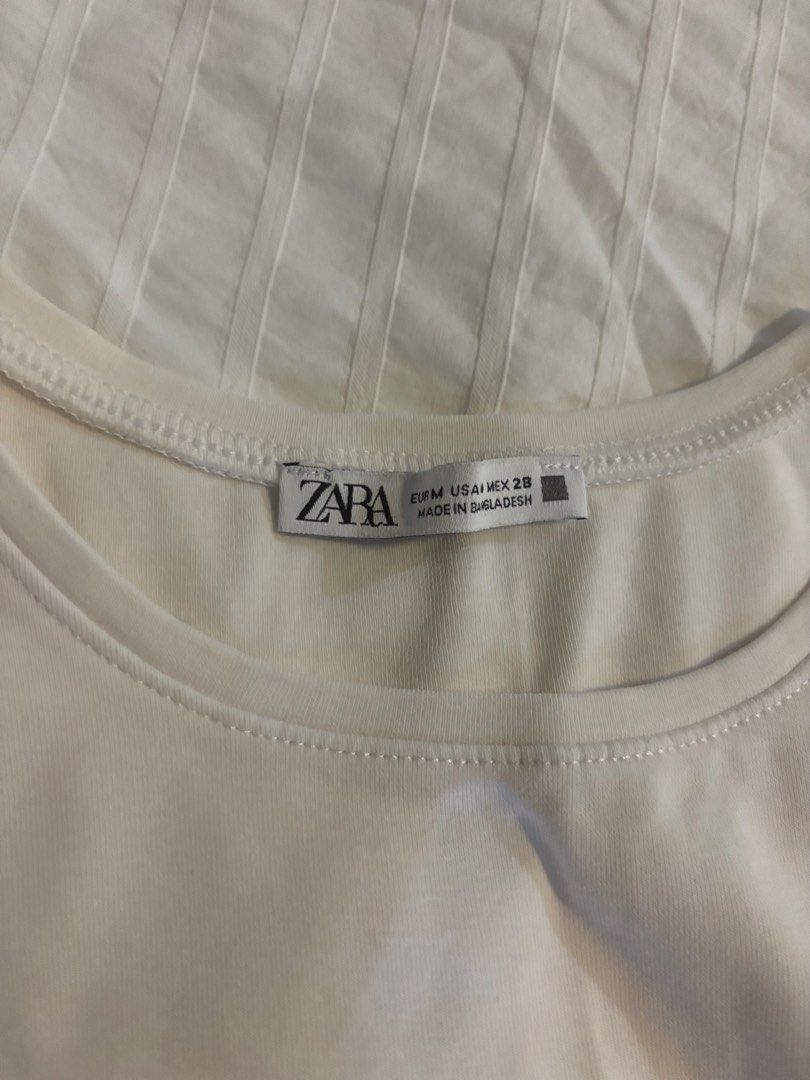 ZARA customized white crop tank top (Category: Sleeveless) located in Quezon City. Submitted by cmtom (Listing ID 1466485473, Image 3). Description: LOC: QC Bought this as plain white tank, i ironed on the black-silver star patch in the middle for the olivia rodrigo concert hehe. Very y2k vibes - Brand: Zara - Style: Sleeveless crop top with crew neckline, garterized bottom edge The garter at the bottom is not so tight na (some parts are wavy) an