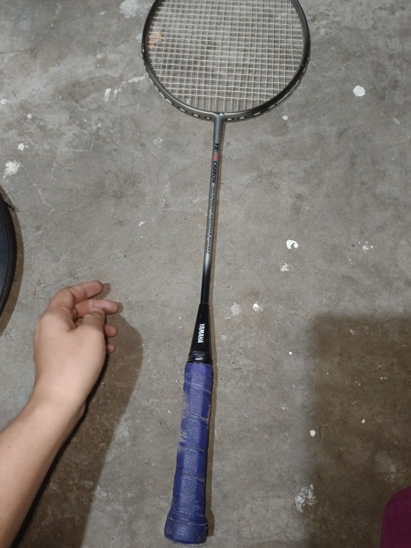 Yamaha YB-76 Badminton Racket (Category: Racket and Ball Sports) located in Valenzuela. Submitted by relchris22 (Listing ID 1466352470, Image 1). Description: - Model: Yamaha YB-76 Carbon - Design: All-carbon graphite racket designed by Yamaha, made in China - Strings: Standard string pattern installed - Grip: Wrapped with a purple overgrip - Condition: Shows minor signs of wear and tear on the frame and grip from regular play.