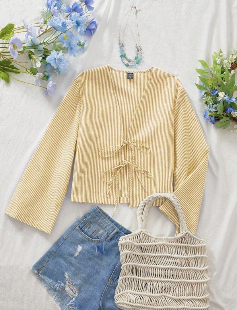 Yellow striped long sleeve tie-front blouse (Category: Blouses) located in Manila. Submitted by sooprmav (Listing ID 1466547847, Image 2). Description: - Yellow and white striped top - Long bell sleeves with cuffs - Tie-front closure at the center - Lightweight fabric with a flattering V-neckline - Easy to pair with jeans or skirts for a clean, comfortable look.