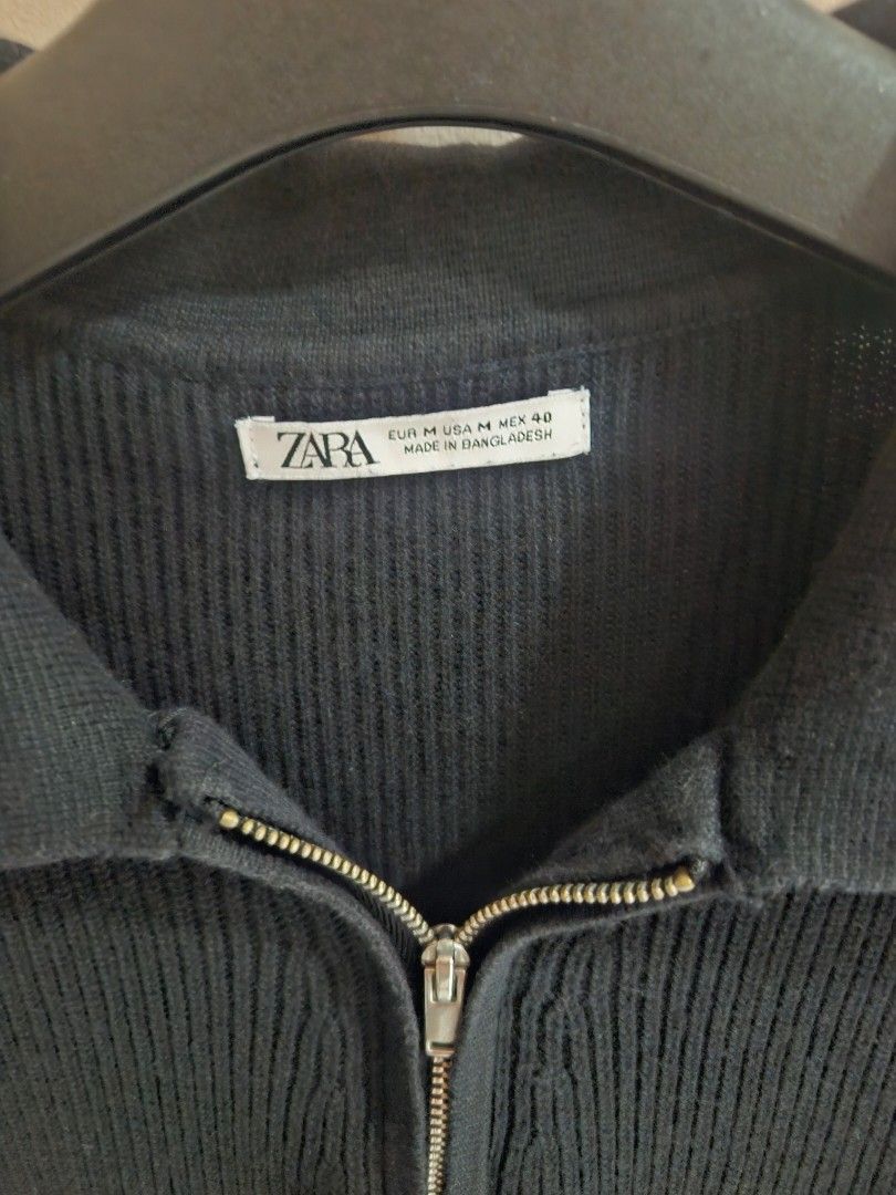 Zara Black Ribbed Zip Sweater Size M (Category: Longsleeves) located in Quezon City. Submitted by phillip31 (Listing ID 1466479289, Image 2). Description: - Brand: Zara - Color: Black - Size: Medium (Regular Fit) - Material: Textured ribbed knit - Features: Half-zip front with collar, long sleeves, ribbed cuffs - Condition: Excellent - Origin: Made in Bangladesh - Style: Versatile everyday piece, perfect for pairing with jeans or trousers.