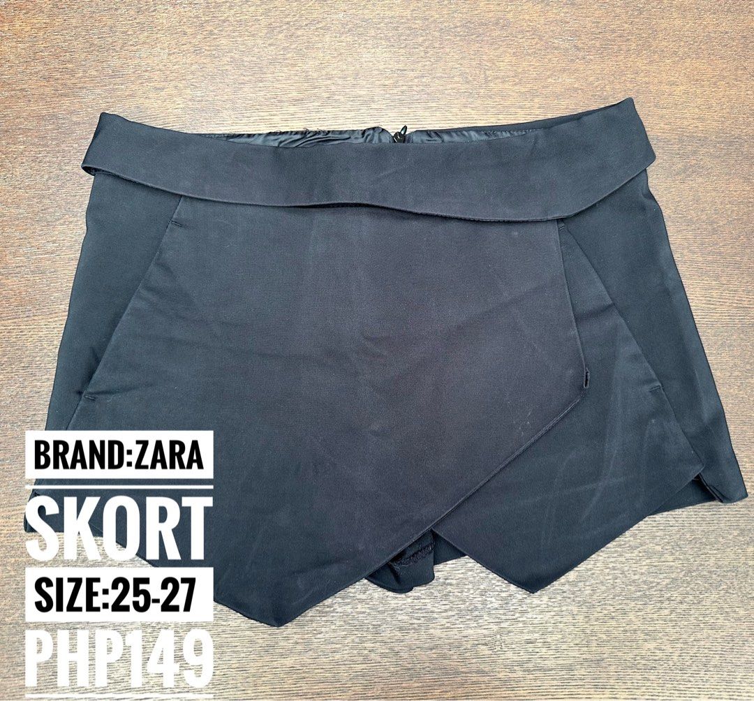 Zara Black Skort (Category: Skirts) located in Bulacan. Submitted by thriftbagcollections (Listing ID 1466356591, Image 1). Description: - Brand: Zara Basic - Size: S / 26 - Made in Turkey - Color: Solid black (versatile for any outfit) - Design: Asymmetric wrap-around front panel - Closure: Hidden back zipper - Comfort: Soft fabric interior lining - Condition: Excellent.