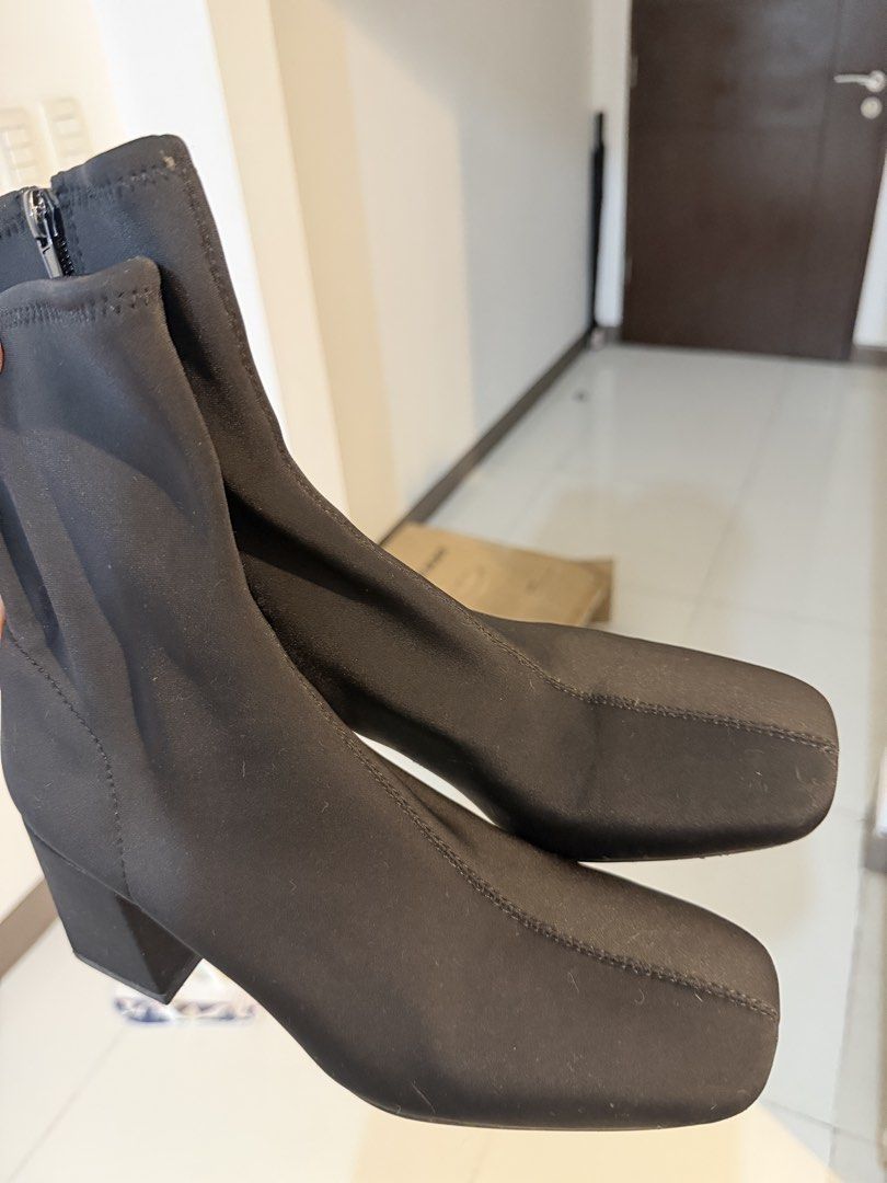 Zara Black Square Toe Heeled Boots Size 37 (Category: Boots) located in Taguig. Submitted by mengxir20193848 (Listing ID 1466524403, Image 2). Description: - Brand: Zara - Style: Stretch fabric ankle boots with square toe and chunky block heel - Size: 37 (marked on inner insole and sole) - Closure: Side zipper for easy wear - Condition: Clean soles with minimal wear, as seen in photos - Perfect for daily wear, work, or night outs!.