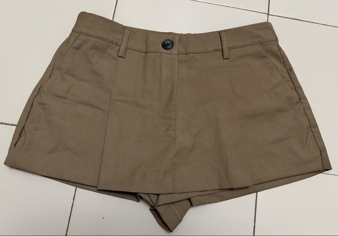 Zara Khaki Skort with Blue Stripe Layer (Category: Shorts) located in Angeles City. Submitted by thon-thal (Listing ID 1466414419, Image 2). Description: Khaki skort from Zara with a layered design. Exposed blue and white striped fabric peeking out at the bottom hem. Front button closure and belt loops. Tailored front panel over built-in shorts. Back tag still attached. size 30 .