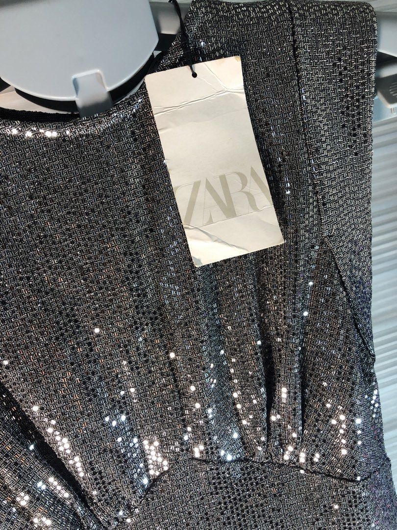 Zara Silver Glitter Metallic Mini Dress (Category: Dresses) located in Manila. Submitted by all.dressed.up (Listing ID 1466386279, Image 3). Description: Brand: Zara Style: Sleeveless mini dress with rounded neckline and keyhole back button Color/Finish: Eye-catching silver glitter Fit: Fitted silhouette with subtle waist pleating Details: Fully lined interior, original retail tags attached Size: S Condition: Brand new WYSIWYG Strictly no return/