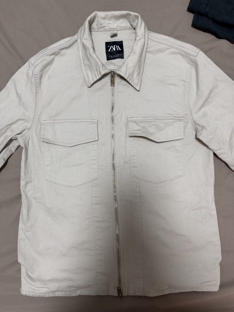 Zara Zip-Up Overshirt Cream Size M (Category: Coats, Jackets and Outerwear) located in Manila. Submitted by poreberqueeen (Listing ID 1466354421, Image 1). Description: - Brand: Zara - Style: Zip-up overshirt - Color: Cream - Size: M (Regular fit) - Material: Durable cotton twill with a structured feel - Features: Full front metal zipper, classic pointed collar, two chest flap pockets - Condition: Worn a few times, minimal signs of wear - Versati