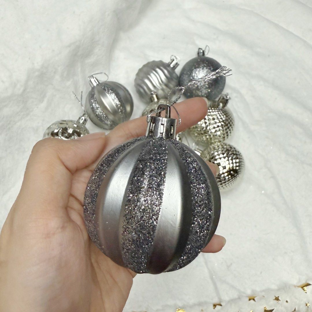 12pcs Silver christmas baubles tree decorations set (Category: Vintage Collectibles) located in Marikina City. Submitted by lovegoeson (Listing ID 1466595995, Image 2). Description: - Set of assorted silver Christmas baubles - Includes glitter, ribbed, patterned, and textured metallic finishes - Comes with a convenient silver hanging loop on each ornament - Great mix of styles to elevate your holiday tree decor.
