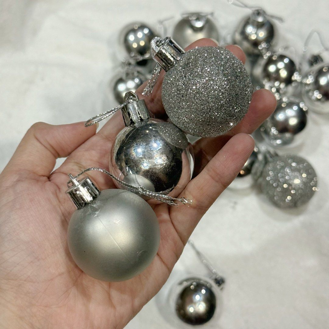 20pcs set Silver Christmas Tree Baubles Ornaments Set (Category: Other Home Decor) located in Marikina City. Submitted by lovegoeson (Listing ID 1466484238, Image 2). Description: - Set of ~20 silver Christmas baubles - Mix of shiny, matte, and glittery finishes - Includes attached strings, ready to hang - Perfect for holiday and tree decorating - Available for pick-up or shipping.