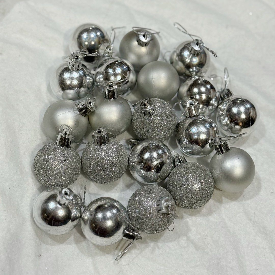 20pcs set Silver Christmas Tree Baubles Ornaments Set (Category: Other Home Decor) located in Marikina City. Submitted by lovegoeson (Listing ID 1466484238, Image 1). Description: - Set of ~20 silver Christmas baubles - Mix of shiny, matte, and glittery finishes - Includes attached strings, ready to hang - Perfect for holiday and tree decorating - Available for pick-up or shipping.
