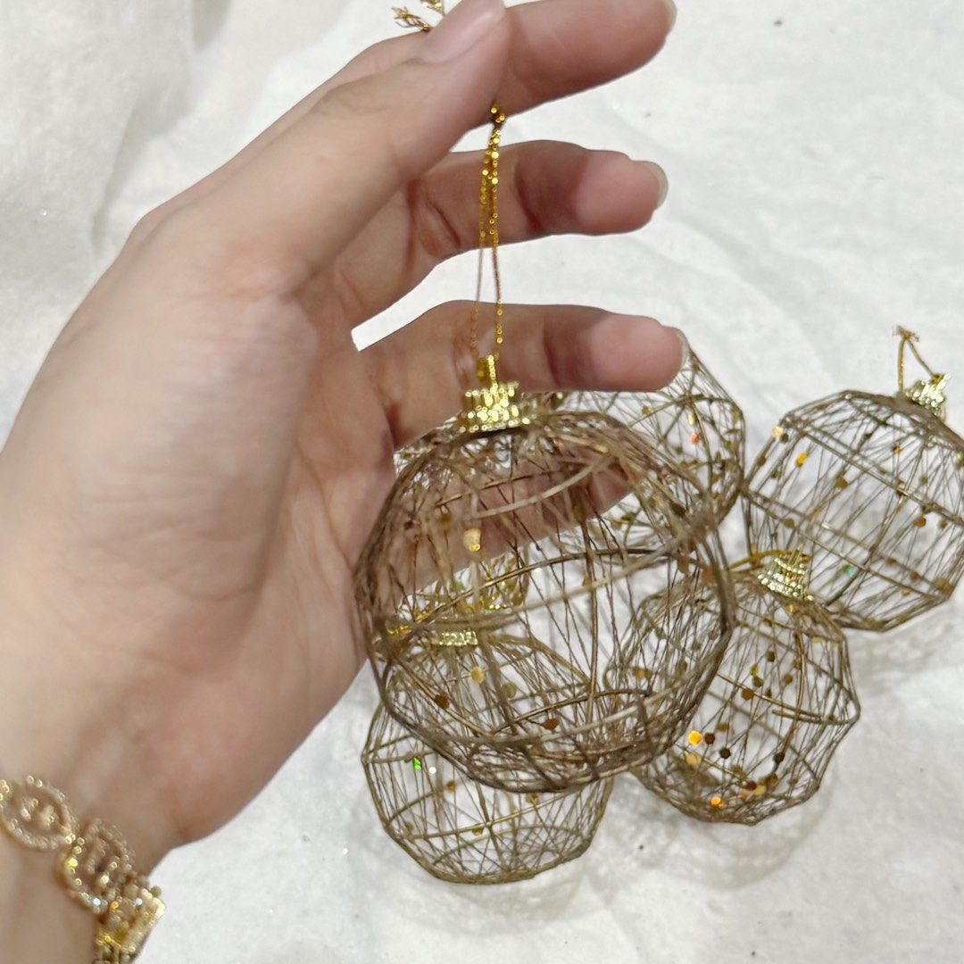 6pcs SET Gold Wire Christmas Tree Ornaments (Category: Vintage Collectibles) located in Marikina City. Submitted by lovegoeson (Listing ID 1466576615, Image 2). Description: - Set of 6 round wire ornaments for holiday decor - Elegant metallic gold finish with shimmering glitter accents - Lightweight woven wire design won't weigh down tree branches - Includes a small loop at the top with matching gold hanging string - Beautiful rustic style to ele