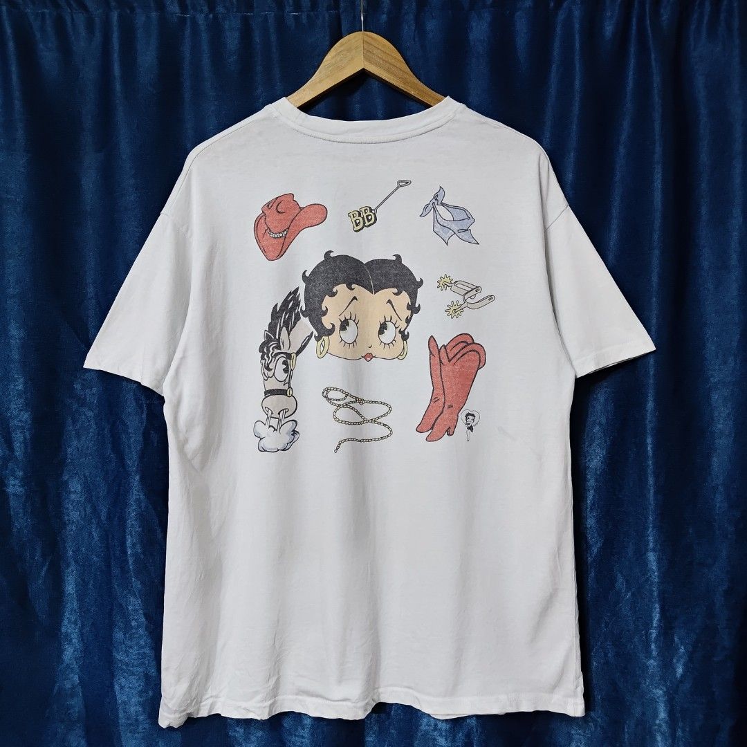 90's BRONCO BETTY BOOP BOOTLEG TEE (Category: Tshirts & Polo Shirts ) located in Makati City. Submitted by upcycled.closeth (Listing ID 1466584823, Image 2). Description: - Authentic 90's Betty boop product - White, short-sleeved - Size: Medium to large (men's) - Like new - Authentic - flaws: cut tag - Excellent condition - Need wash, fresh from bale - Features design of 90's Betty boop bronco tee - Material: 100% cotton !!STILL NEGOTIABLE!!.
