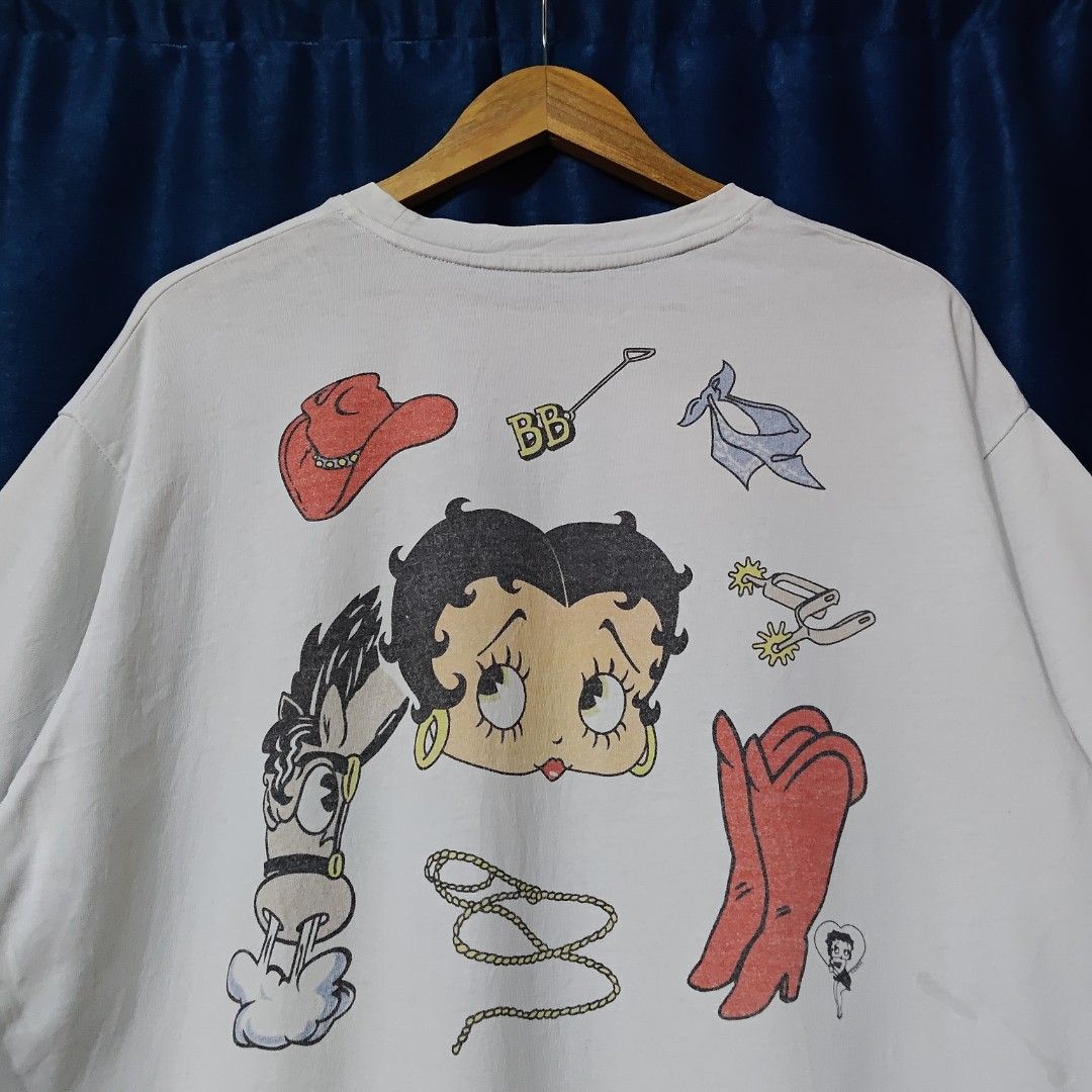 90's BRONCO BETTY BOOP BOOTLEG TEE (Category: Tshirts & Polo Shirts ) located in Makati City. Submitted by upcycled.closeth (Listing ID 1466584823, Image 3). Description: - Authentic 90's Betty boop product - White, short-sleeved - Size: Medium to large (men's) - Like new - Authentic - flaws: cut tag - Excellent condition - Need wash, fresh from bale - Features design of 90's Betty boop bronco tee - Material: 100% cotton !!STILL NEGOTIABLE!!.