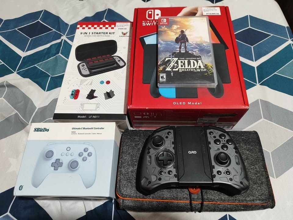 🎮 NINTENDO SWITCH OLED COMPLETE BUNDLE + ZELDA BOTW + 2 EXTRA CONTROLLERS (Category: Nintendo) located in Manila. Submitted by luna.2214 (Listing ID 1466648337, Image 1). Description: 🎮 NINTENDO SWITCH OLED COMPLETE BUNDLE + ZELDA BOTW + 2 EXTRA CONTROLLERS 💰 PRICE: ₱16,000 — SLIGHTLY NEGOTIABLE Selling my Nintendo Switch OLED complete with original accessories, Zelda: Breath of the Wild physical copy, 2 extra controllers, and multiple cases/a