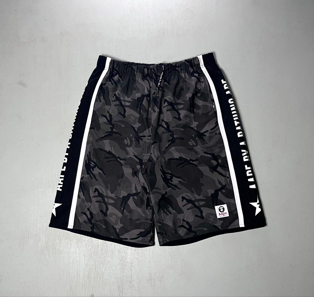 Aape Reversible Short Authentic (Category: Shorts) located in Catbalogan. Submitted by yellfindss (Listing ID 1466750395, Image 1). Description: - Brand: Aape by A Bathing Ape -30-36/21.5 - Style: Reversible shorts with dark camo pattern and side stripe branding - Size: L (180/86A) - Condition: Excellent, well-maintained - Features: Elastic waistband with drawstring, iconic logos and text print along the sides - Perfect for daily casual wear and 