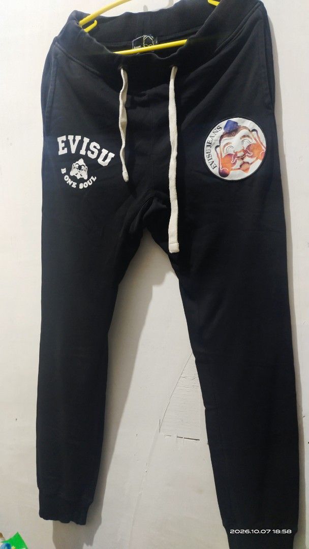 Aape x Evisu Black Sweatpants Size L (Category: Joggers) located in Manila. Submitted by rhobin.m08 (Listing ID 1466694280, Image 1). Description: - Brand: Aape x Evisu - Color: Black - Size: Large (L) - Material: 100% premium cotton for all-day comfort - Design: Features eye-catching Evisu and B One Soul front graphics - Back Detail: Signature Evisu pocket graphic - Fit & Features: Adjustable white drawstring waist and ribbed ankle cuffs - Condi