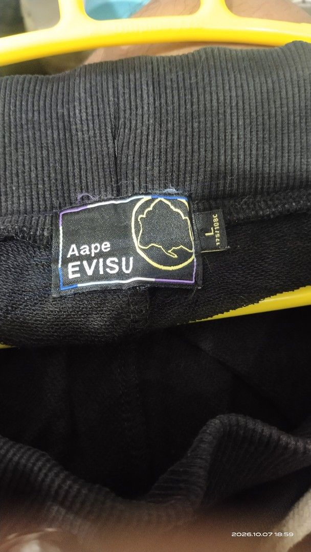 Aape x Evisu Black Sweatpants Size L (Category: Joggers) located in Manila. Submitted by rhobin.m08 (Listing ID 1466694280, Image 3). Description: - Brand: Aape x Evisu - Color: Black - Size: Large (L) - Material: 100% premium cotton for all-day comfort - Design: Features eye-catching Evisu and B One Soul front graphics - Back Detail: Signature Evisu pocket graphic - Fit & Features: Adjustable white drawstring waist and ribbed ankle cuffs - Condi
