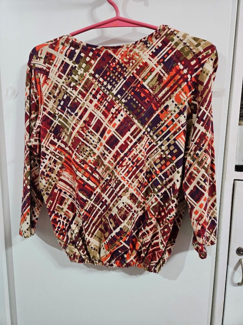 Abstract Geometric Print Long Sleeve Blouse Top (Category: Longsleeves) located in Caloocan City. Submitted by rm.diaz (Listing ID 1466752134, Image 2). Description: - Design: Vibrant red, orange, purple, and cream abstract geometric pattern - Neckline: V-neck with subtle front button detailing - Sleeves: Long sleeves with a comfortable elastic hemline - Material: Soft, high-quality fabric - Styling: Versatile piece, easy to pair with skirts or t
