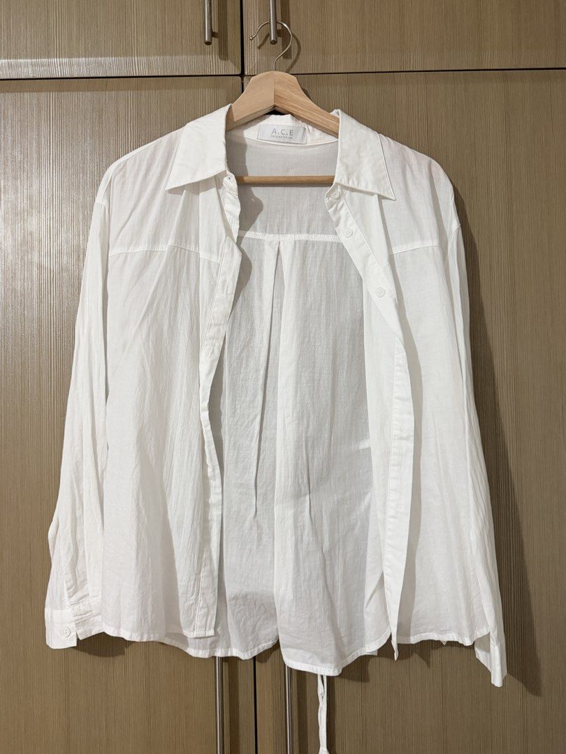 A.C.E. Designed in Korea White Button-Up Shirt (Category: Shirts) located in Taguig. Submitted by mengxir20193848 (Listing ID 1466673040, Image 1). Description: - Brand: A.C.E. (Designed in Korea) - Color: Classic White - Style: Korean streetwear, versatile neutral staple - Fit/Material: Lightweight, slightly sheer, long sleeves with classic collar and front button closure - Versatility: Easy to wear solo or layer over a tank top.