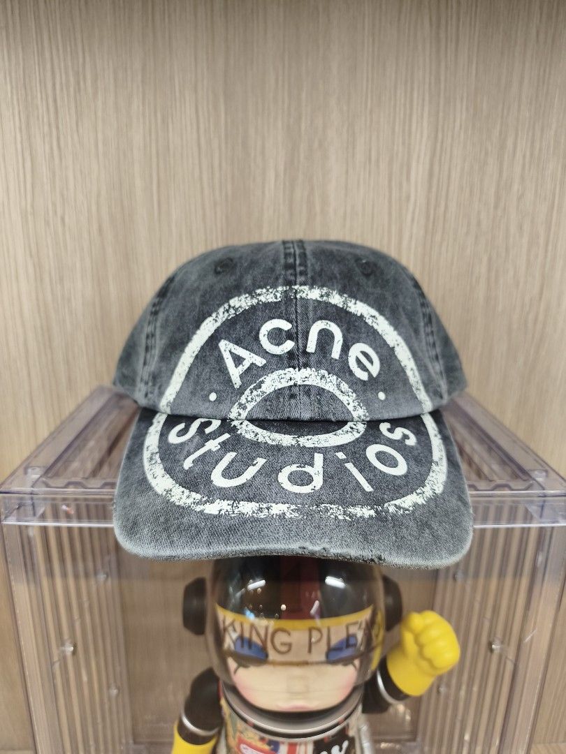 Acne Studios Distressed Logo Cap Grey (Category: Caps & Hats) located in Taytay. Submitted by bunsoanglo096 (Listing ID 1466653772, Image 3). Description: - Brand: Acne Studios - Color/Material: Washed grey denim - Design: Six-panel cap with eyelets and distressed brim details - Branding: Large white stamped circular logo on the front - Fit: Adjustable strap back closure - Style: Great piece for everyday casual outfits.