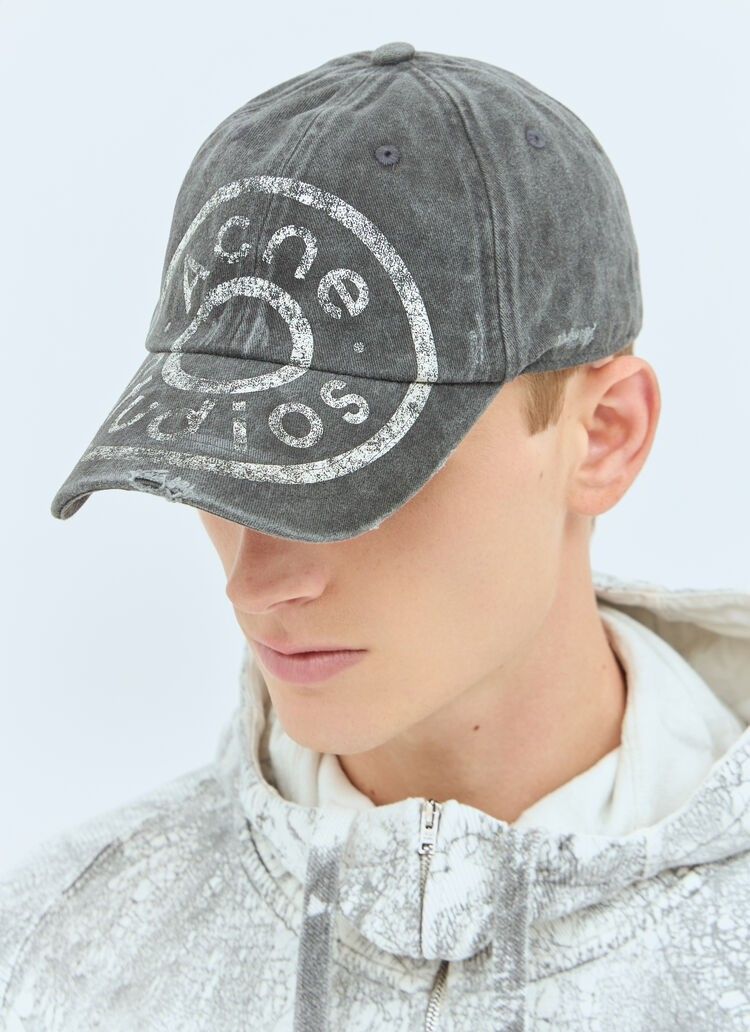 Acne Studios Distressed Logo Cap Grey (Category: Caps & Hats) located in Taytay. Submitted by bunsoanglo096 (Listing ID 1466653772, Image 1). Description: - Brand: Acne Studios - Color/Material: Washed grey denim - Design: Six-panel cap with eyelets and distressed brim details - Branding: Large white stamped circular logo on the front - Fit: Adjustable strap back closure - Style: Great piece for everyday casual outfits.