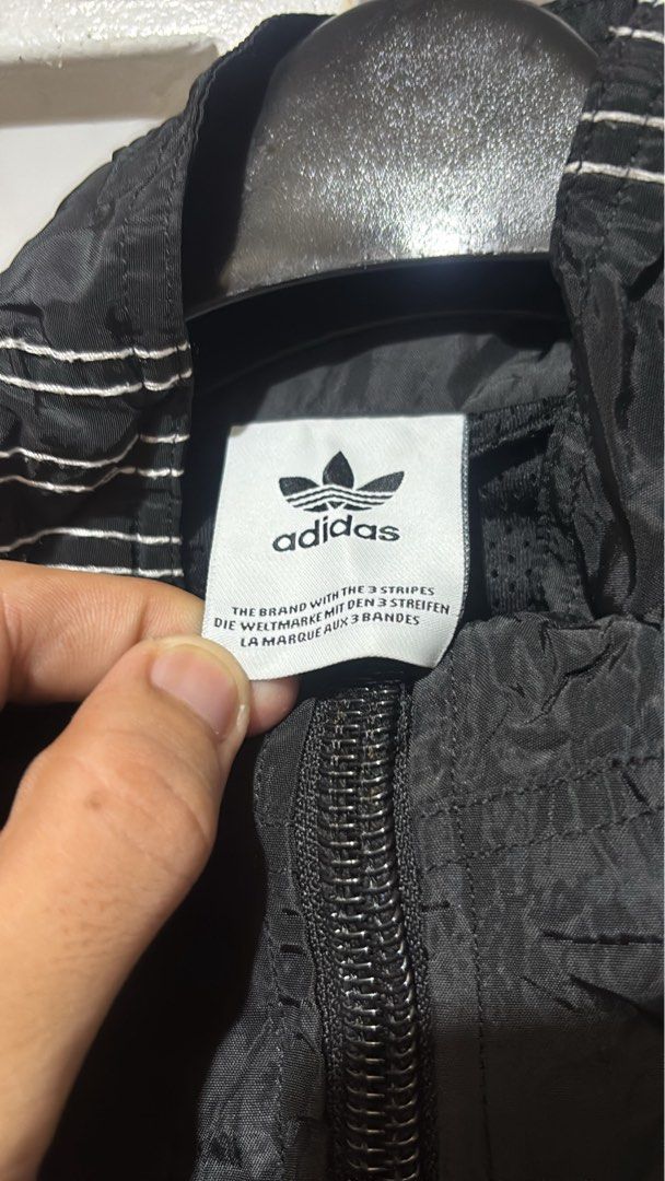 Adidas Black Half-Zip Windbreaker Jacket (Category: Coats, Jackets and Outerwear) located in Batangas. Submitted by franzbucal (Listing ID 1466608435, Image 2). Description: - Authentic black Adidas half-zip windbreaker jacket - Classic white 3-stripes down the sleeves with embroidered trefoil logo on the chest - Lightweight, crinkled nylon material ideal for Philippine weather - High neckline with sturdy zipper pull - Adjustable drawstring hem f