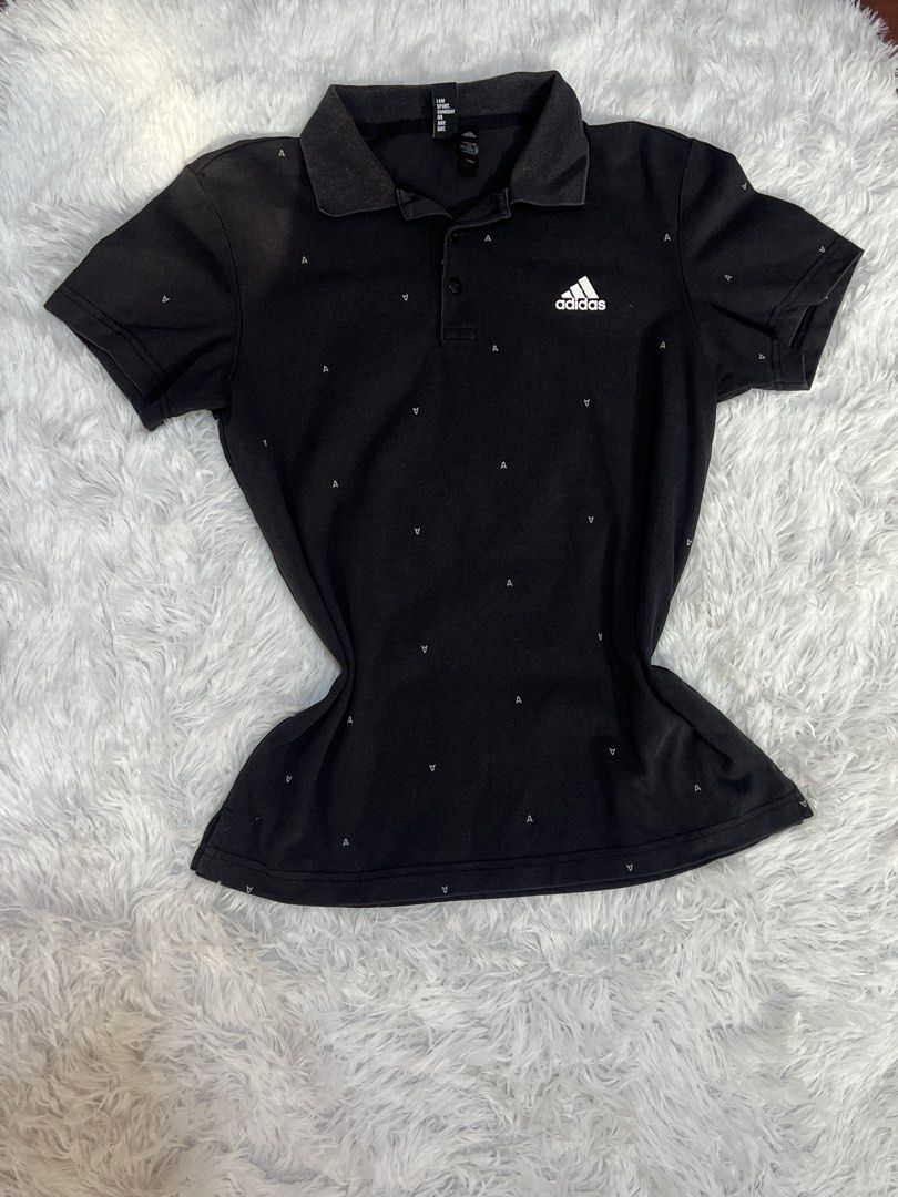 Adidas Black Monogram Polo Shirt (Category: Tshirts & Polo Shirts ) located in Tuguegarao City. Submitted by love_clothies (Listing ID 1466572679, Image 1). Description: - Brand: Adidas - Color: Black with all-over small 'A' monogram print - Design: Short sleeves, classic collar neckline, and three-button placket - Branding: White Adidas logo printed on the left chest - Tagline: 'I am sport. Gameday or any day' - Material: Comfortable fabric, eas