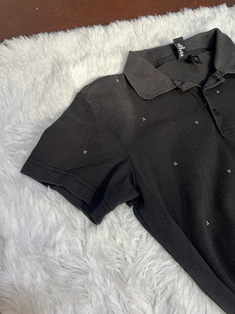 Adidas Black Monogram Polo Shirt (Category: Tshirts & Polo Shirts ) located in Tuguegarao City. Submitted by love_clothies (Listing ID 1466572679, Image 3). Description: - Brand: Adidas - Color: Black with all-over small 'A' monogram print - Design: Short sleeves, classic collar neckline, and three-button placket - Branding: White Adidas logo printed on the left chest - Tagline: 'I am sport. Gameday or any day' - Material: Comfortable fabric, eas