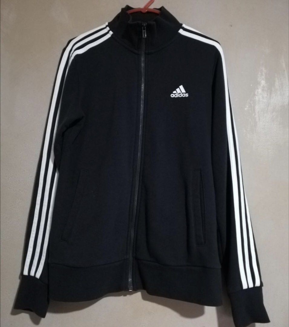 Adidas Black Track Jacket with White Stripes (Category: Coats, Jackets and Outerwear) located in Marikina City. Submitted by sakura_07 (Listing ID 1466668679, Image 1). Description: - Brand/Style: Classic Adidas black track jacket - Design: White three-stripe branding on sleeves with embroidered logo on chest - Features: Full front zipper, stand-up collar, and two front welt pockets - Fit/Comfort: Ribbed cuffs and hem to maintain shape - Versatil