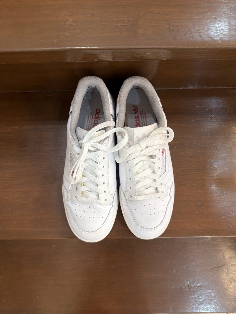 Adidas Continental 80 White Sneakers (Category: Sneakers) located in San Juan City. Submitted by hazeldee (Listing ID 1466713396, Image 1). Description: - Brand: Adidas Continental 80 - Color: White leather with red and navy side stripes - Condition: Clean white soles, minimal toe box creasing - Packaging: Comes in original blue Adidas box 100% Authentic Used less than 5 times Excellent condition US 7.5 UK 7 CHN 250 25 CM .