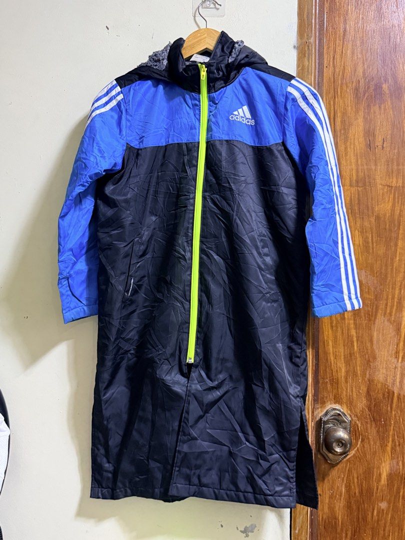 Adidas Long Jacket Blue Black Fleece Lined (Category: Babies & Kids Fashion) located in Paete. Submitted by skydruemadison (Listing ID 1466684699, Image 1). Description: Adidas long jacket in blue and black. Bright green full zip closure down the front. Cozy grey fleece lining inside the upper body and hood. White three stripe branding on the sleeves. Large Adidas logo printed on the back. Hood attached..