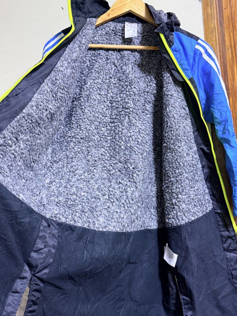 Adidas Long Jacket Blue Black Fleece Lined (Category: Babies & Kids Fashion) located in Paete. Submitted by skydruemadison (Listing ID 1466684699, Image 2). Description: Adidas long jacket in blue and black. Bright green full zip closure down the front. Cozy grey fleece lining inside the upper body and hood. White three stripe branding on the sleeves. Large Adidas logo printed on the back. Hood attached..