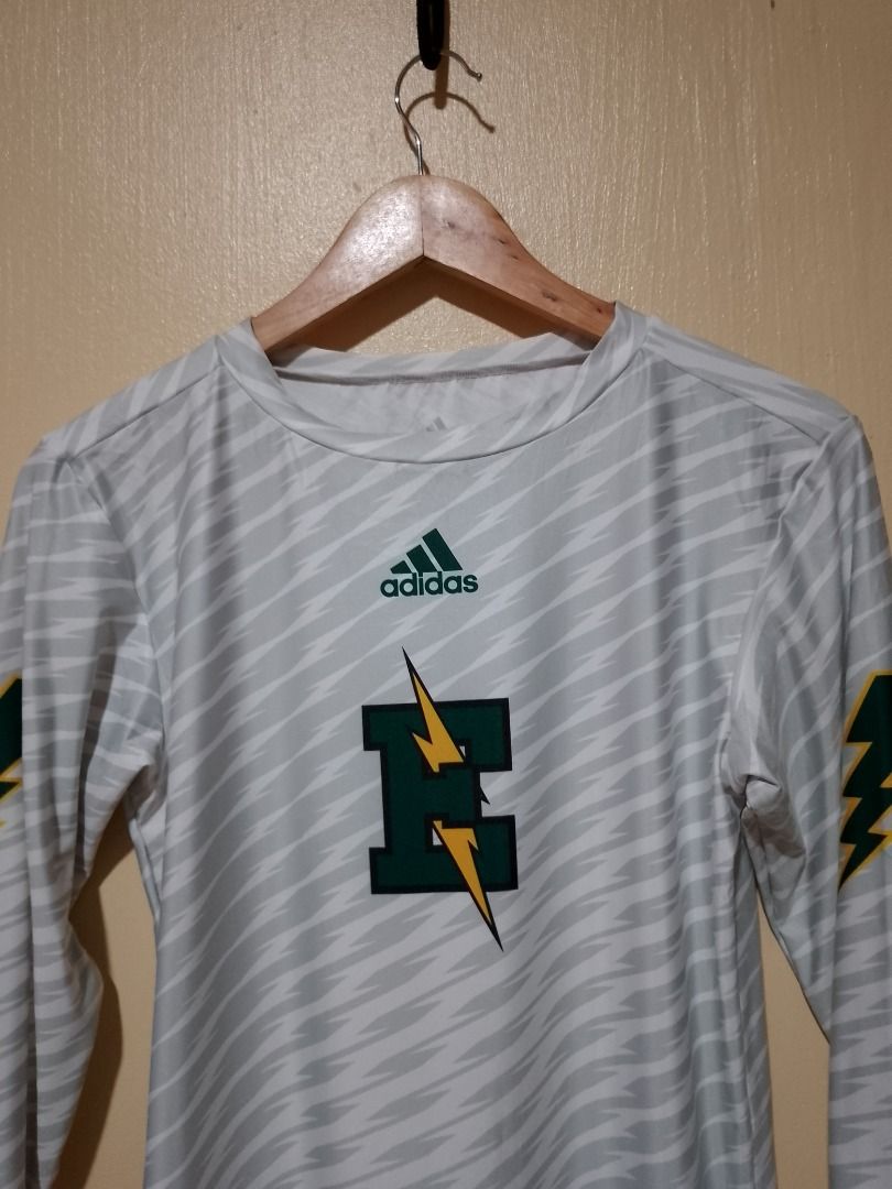 Adidas Long Sleeve Athletic Jersey White Green (Category: Activewear) located in Bayombong. Submitted by daily10 (Listing ID 1466565738, Image 3). Description: Est Size: XL tag (Women's Small) Dimensions: 16" x 26" inches - Brand: Adidas - Type: Athletic long sleeve shirt - Color/Pattern: White with grey abstract pattern - Graphics: Green and yellow lightning bolts on sleeves, large green E logo with lightning bolts on chest - Material: 85% polye