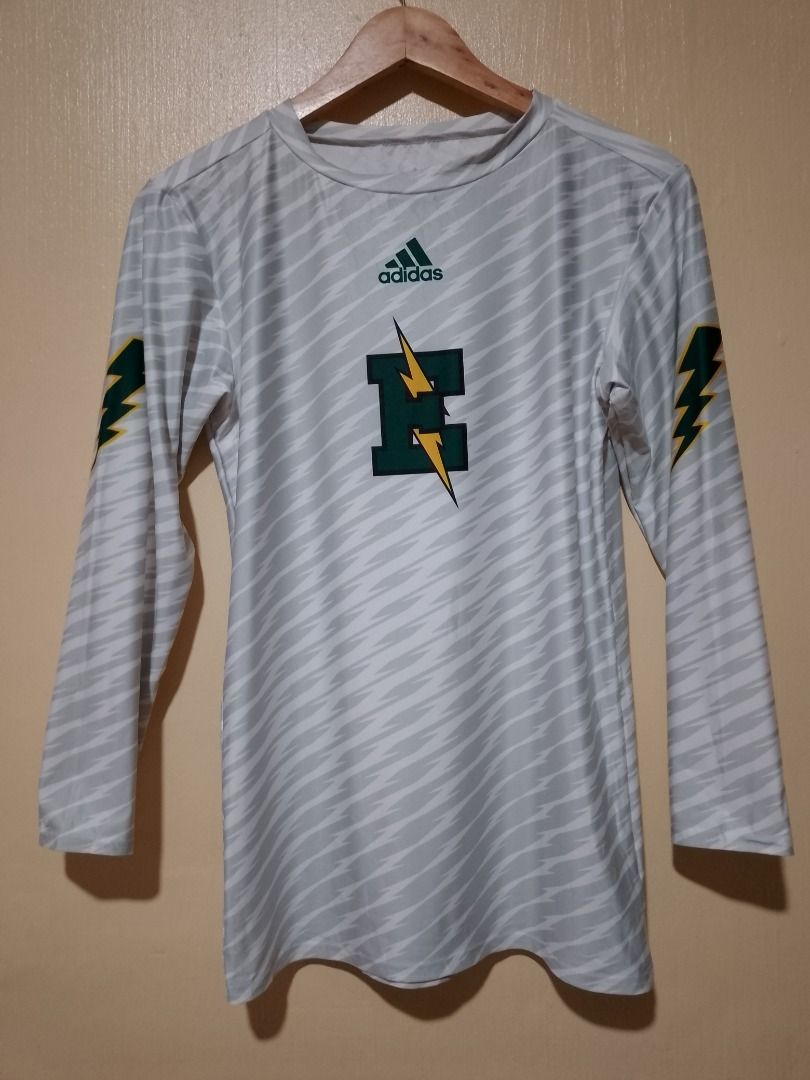 Adidas Long Sleeve Athletic Jersey White Green (Category: Activewear) located in Bayombong. Submitted by daily10 (Listing ID 1466565738, Image 2). Description: Est Size: XL tag (Women's Small) Dimensions: 16" x 26" inches - Brand: Adidas - Type: Athletic long sleeve shirt - Color/Pattern: White with grey abstract pattern - Graphics: Green and yellow lightning bolts on sleeves, large green E logo with lightning bolts on chest - Material: 85% polye