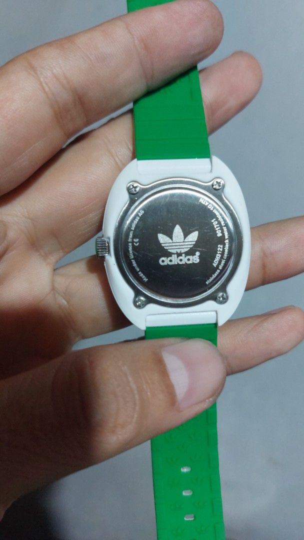 Adidas Stan Smith ADH3122 White Green Watch (Category: Women's Watches) located in Santa Cruz. Submitted by tovybonacruz (Listing ID 1466595234, Image 2). Description: - Model: Adidas Stan Smith ADH3122 - Dial: White with green accents and Stan Smith branding - Strap: White silicone with perforated details and a contrasting green underside - Caseback: Stainless steel with engraved serial number (901701) - Water Resistance: 10 ATM - Condition: Gua