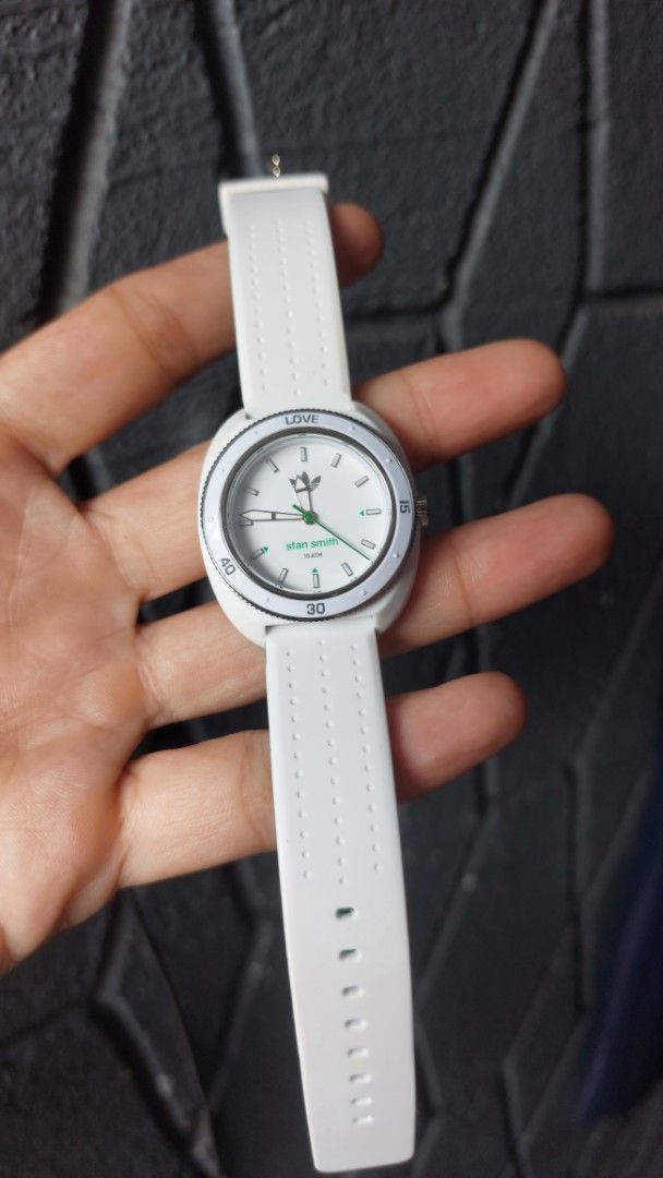 Adidas Stan Smith ADH3122 White Green Watch (Category: Women's Watches) located in Santa Cruz. Submitted by tovybonacruz (Listing ID 1466595234, Image 3). Description: - Model: Adidas Stan Smith ADH3122 - Dial: White with green accents and Stan Smith branding - Strap: White silicone with perforated details and a contrasting green underside - Caseback: Stainless steel with engraved serial number (901701) - Water Resistance: 10 ATM - Condition: Gua