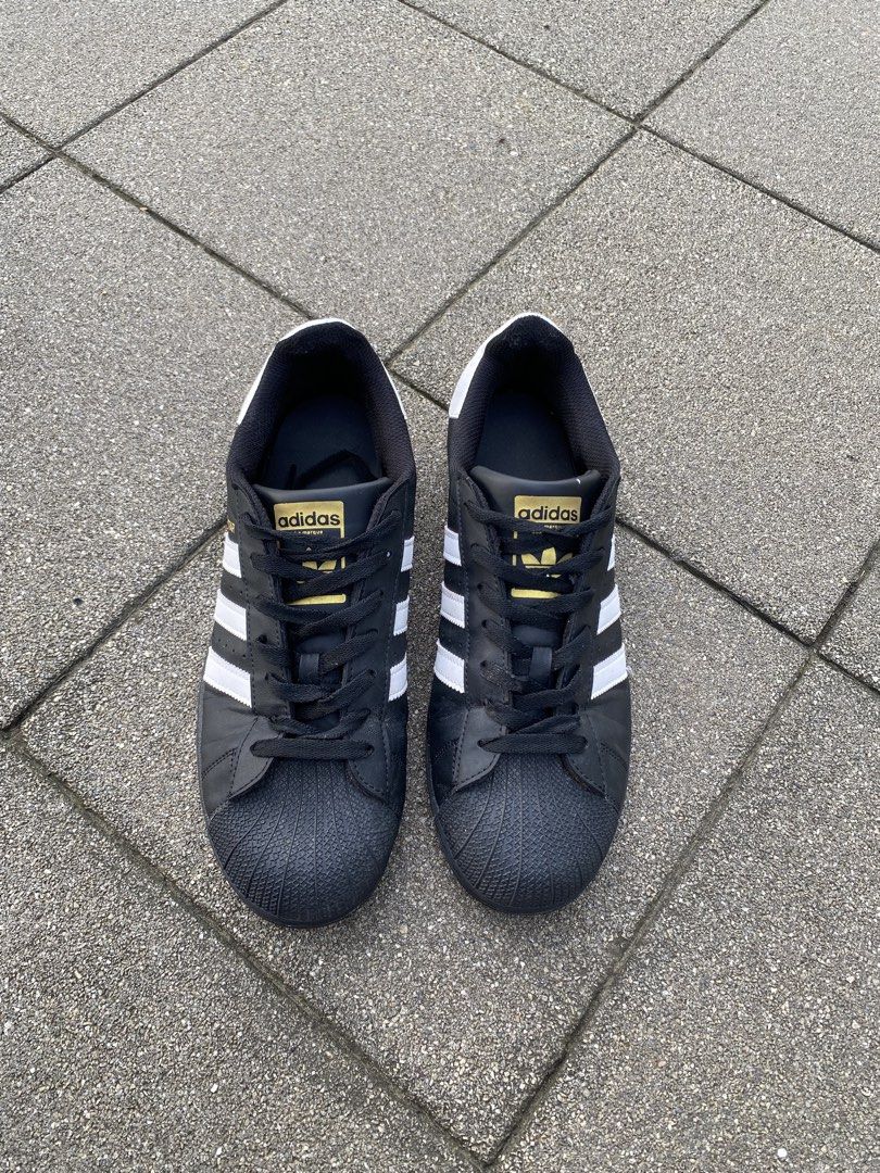 Adidas Superstar Black White (Category: Sneakers) located in Davao. Submitted by thirdy.pfp (Listing ID 1466654409, Image 3). Description: Adidas Superstar Classics 9.5 us / 27.5 cm Excellent 9/10 -1400 - Brand: Adidas Originals - Model: Superstar (Black/White) - Material: Premium leather upper with durable rubber shell toe and outsole - Design: Classic low-top with iconic white stripes, gold foil branding, and white heel tabs - Condition: Pre-ow