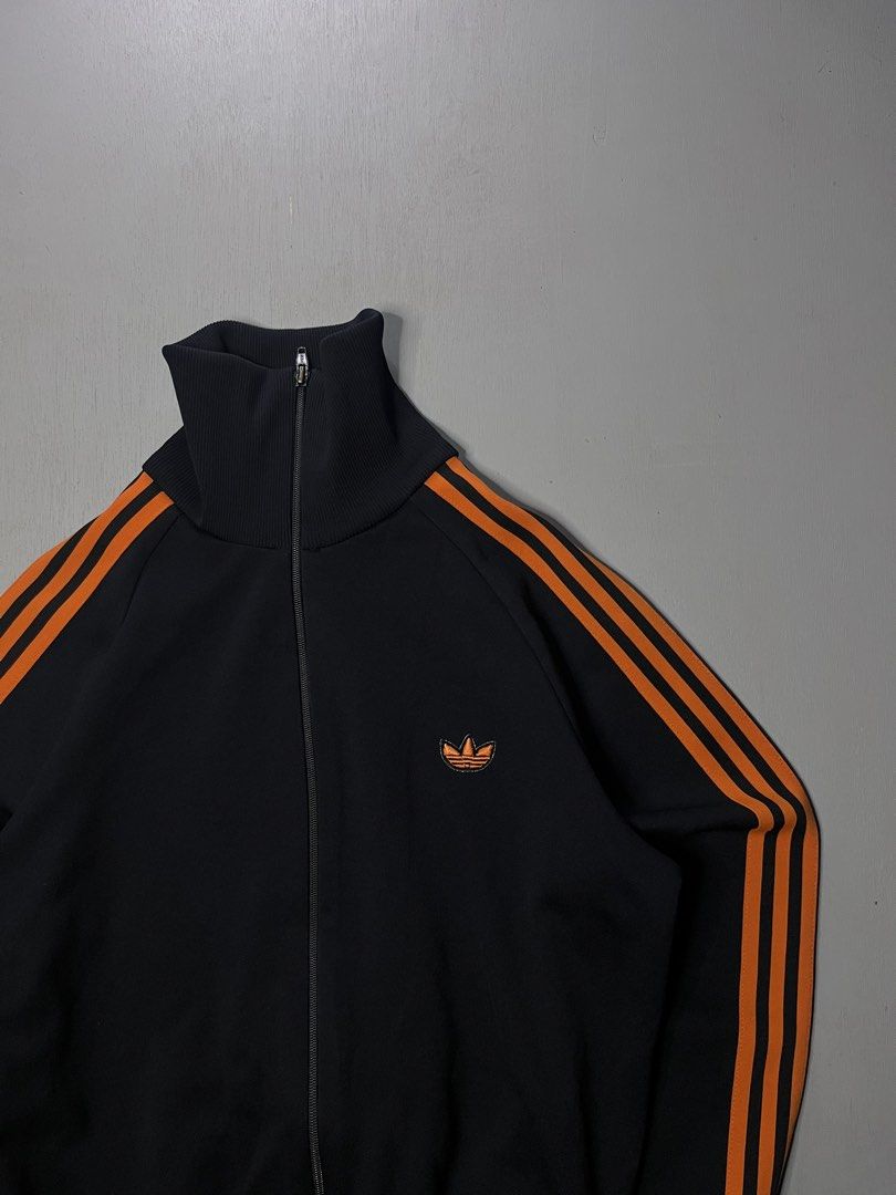 Adidas Track Jacket (Category: Activewear) located in Catbalogan. Submitted by yellfindss (Listing ID 1466744314, Image 2). Description: - Brand: Adidas (Produced by Descente under license) -20.5/23.5 - Model / Style: Vintage Track Jacket with high collar - Color: Classic black with striking orange 3-stripes and embroidered trefoil logo - Size: ADS-4F (Size 2) - Condition: Very good vintage condition, clean fabric and smooth zipper - Perfect for 