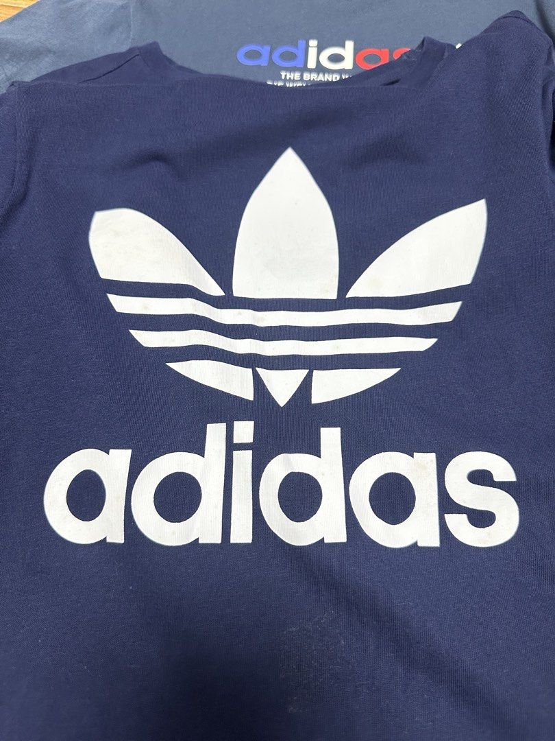 Adidas T-Shirt Bundle Set 3pcs (Category: Babies & Kids Fashion) located in Balagtas. Submitted by momandkidstuffph (Listing ID 1466575473, Image 2). Description: - Bundle of 3: Blue, black, and dark blue - Design: Iconic Adidas chest logos and branding - Material: 100% breathable cotton - Fit & Style: Short sleeves, crew neck - Versatile: Ideal for casual daily wear or workouts - Message us for bundle inquiries or more details! measurements prov
