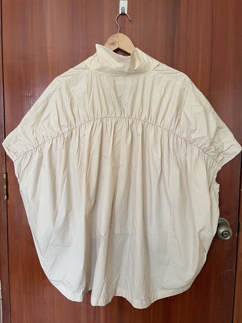 Africa Beige Oversized Button-Up Short Sleeve Blouse (Category: Blouses) located in Cebu City. Submitted by annyeongthriftcebu (Listing ID 1466632871, Image 2). Description: - Style: Oversized button-up blouse with short sleeves - Color: Versatile neutral beige (goes with everything!) - Origin: From Africa - Details: High collar, front button closure, and adjustable hem tie - Fit & Comfort: Crisp cotton-blend fabric with gathers across the back y
