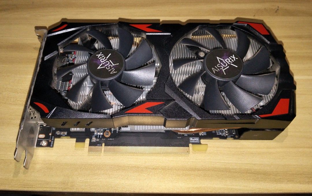 Aisurix AMD RX 580 8GB 2048SP GPU (Category: Computer Parts) located in Marikina City. Submitted by rareocean_9df934 (Listing ID 1466769411, Image 1). Description: - Brand/Model: Aisurix AMD RX 580 - Memory: 8GB VRAM with 2048 stream processors - Cooling: Dual fan setup with copper heat pipes - Design: Sleek black shroud with red accents and backplate with cooling slots - Condition: Clean unit, manufacturer stickers intact, standard PCIe interfac